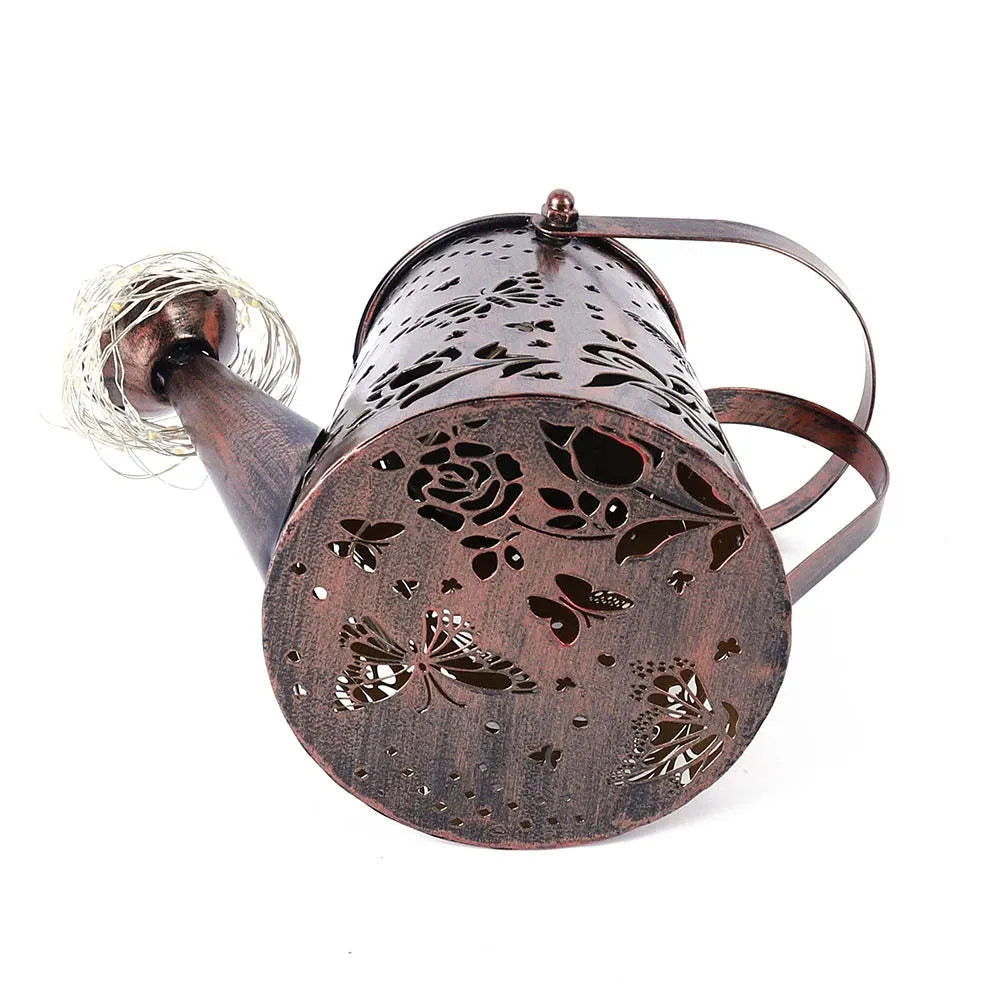 Tapered butterfly pattern iron solar garden lamp with warm white LED light.
