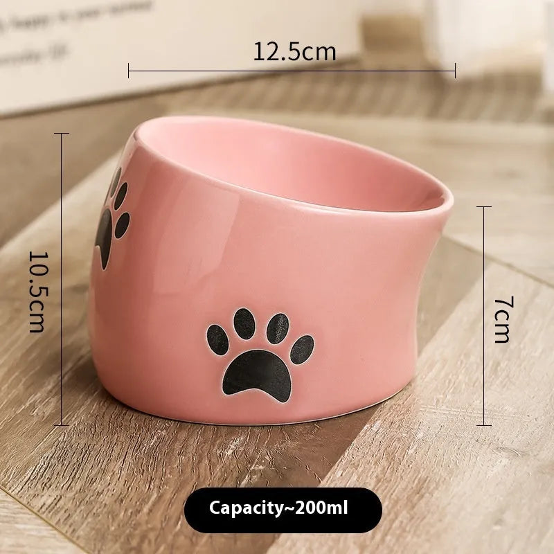 Ceramic cat bowl with cat paw design in black, showing oblique mouth style.