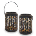 Black iron circular solar lamp with small cylindrical wheat ear design on a garden path