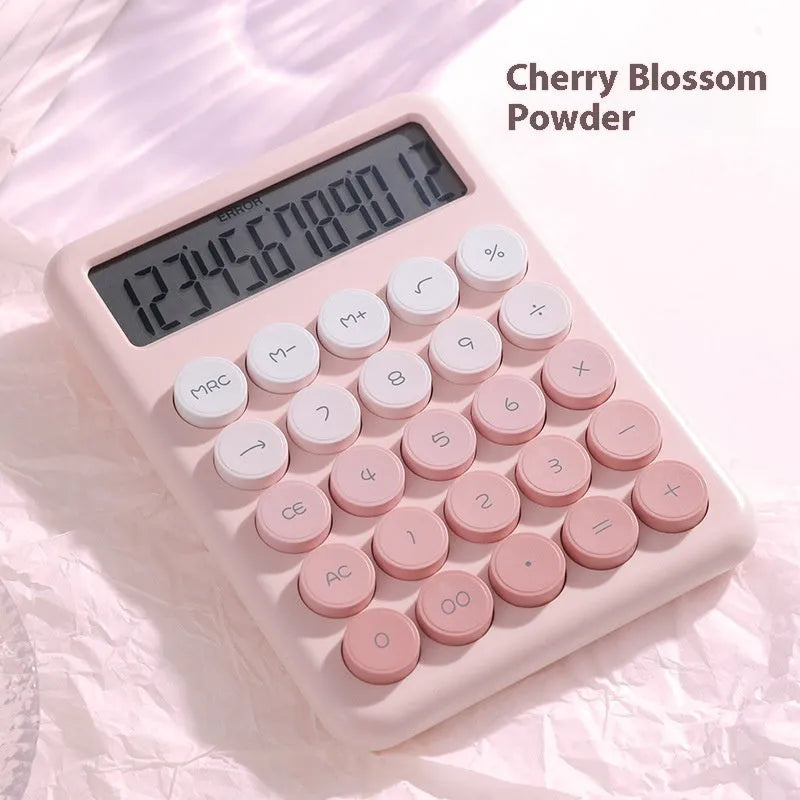 Gradient colour desktop calculator in violet, pink, blue, or green on a desk.