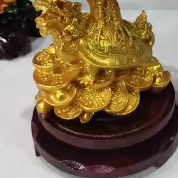 Citrine-coloured resin Feng Shui ornament of a small water turtle money tree on a white background.