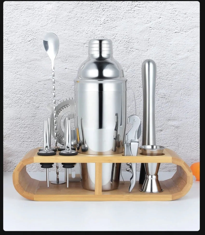 23-piece stainless steel cocktail set with drink mixers on a bar
