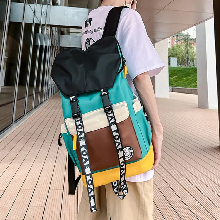 Oxford cloth backpack in black, green, or red with multiple carry handles and straps.