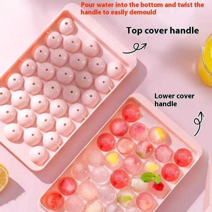 Blue silicone ice tray with lid producing 33 large round ice spheres on a kitchen counter