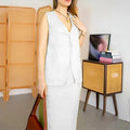 Women's loose blue polyester two-piece suit with sleeveless vest and long skirt on a hanger.