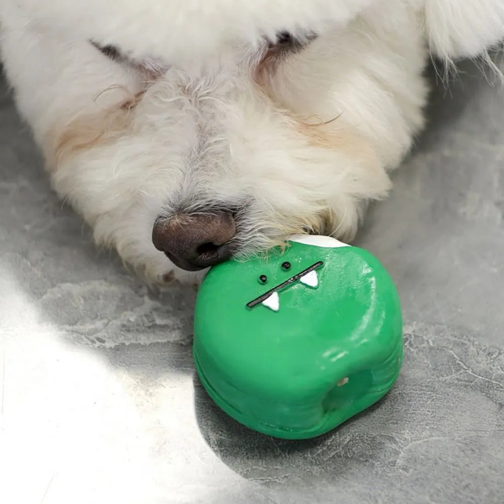 Green and yellow latex dog chew toy shaped like cartoon egg bread with a squeaker.
