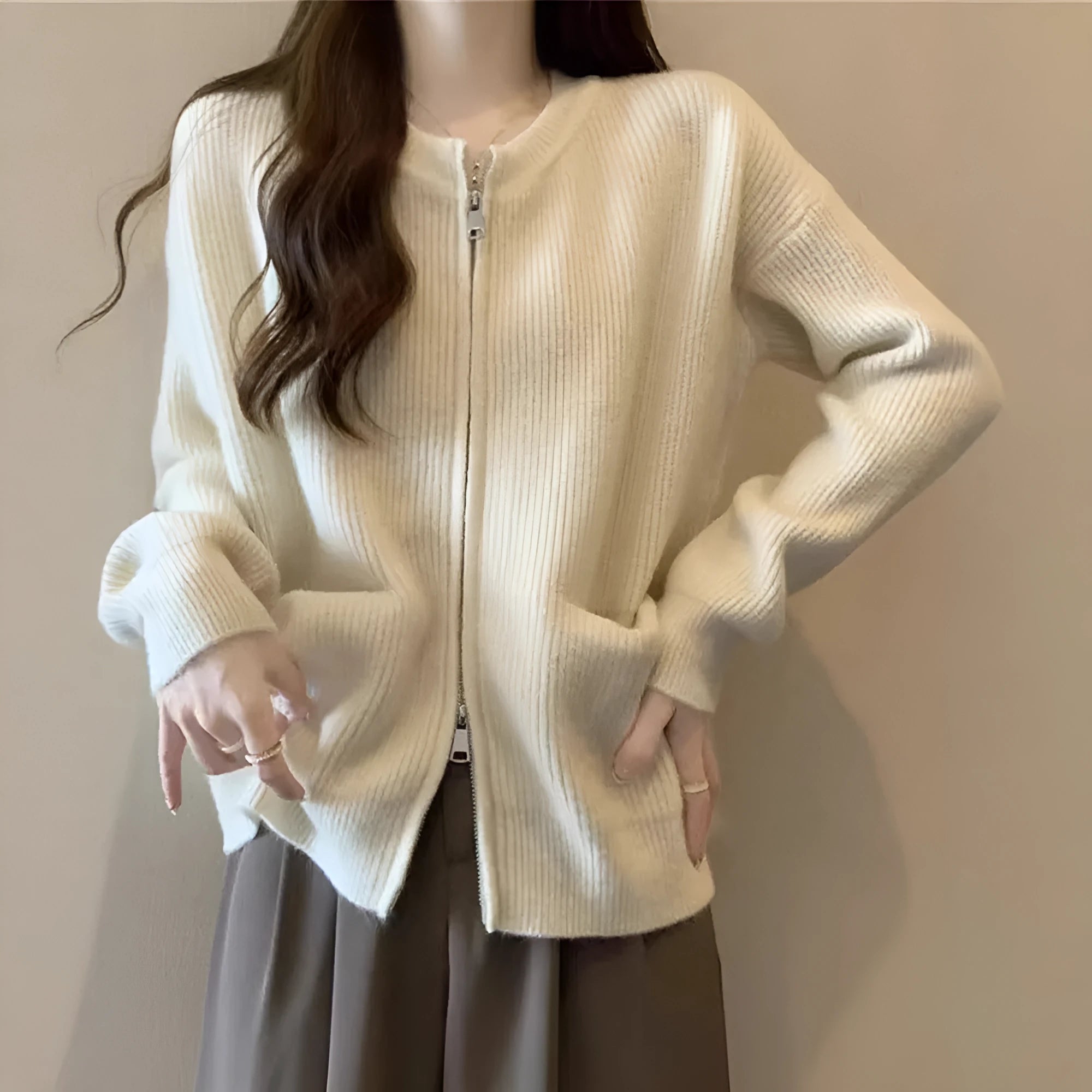 Soft beige viscose fibre sweater coat, a long-sleeve cardigan laid flat.