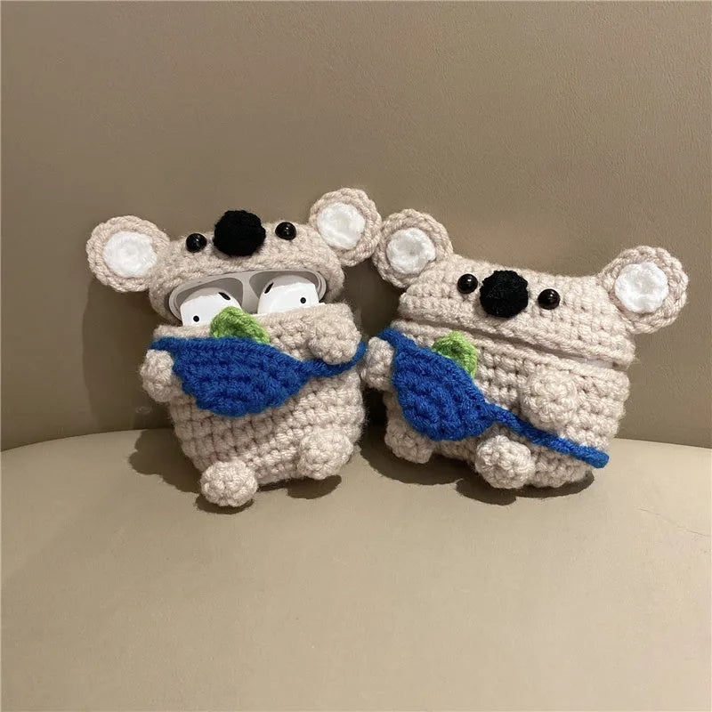 Hand-knitted grey koala bear design cover on a white Airpods case.
