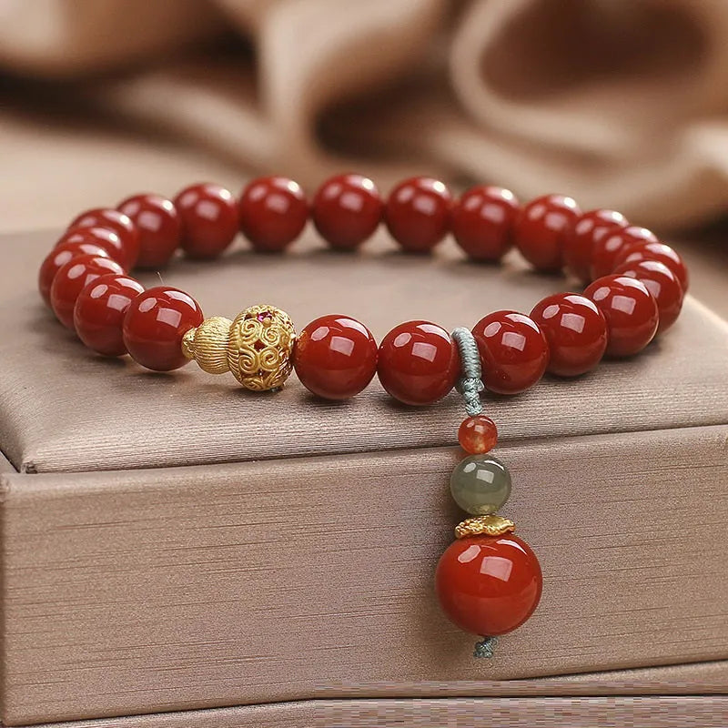 Red agate ethnic style bracelet for women on a plain background