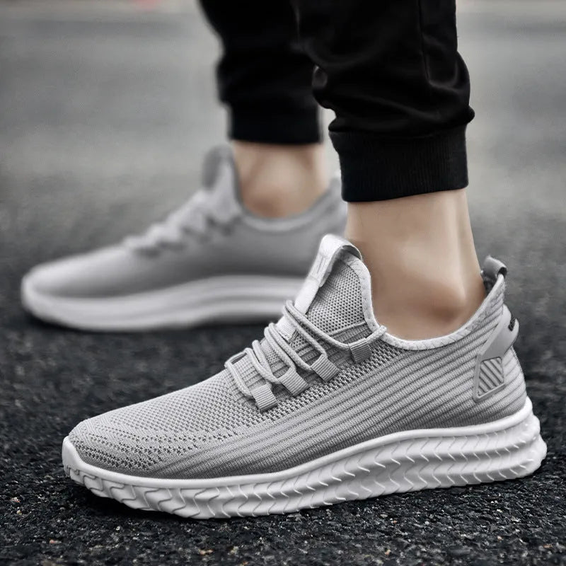 Men's casual shoes with black flying weave upper, rubber sole, and front tie lacing