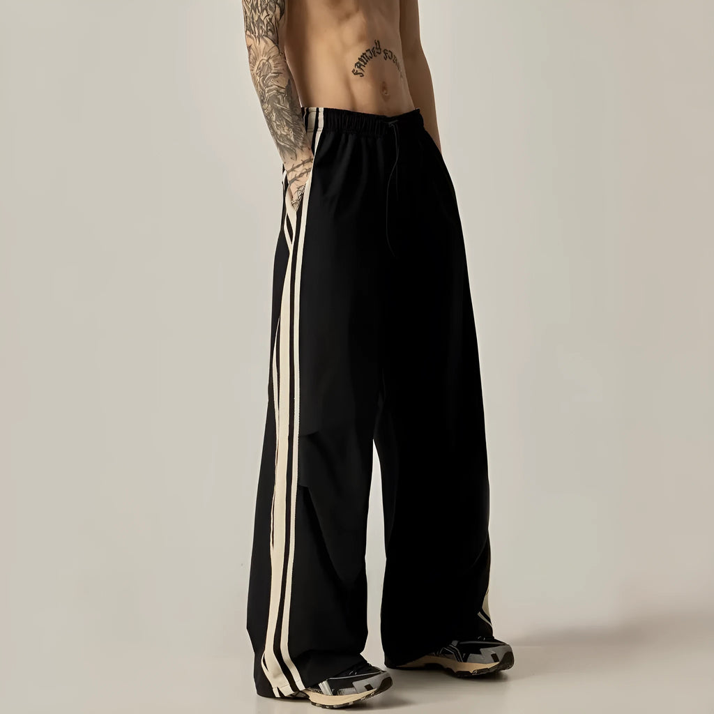 Black men's high-waisted wide-leg casual trousers laid flat.