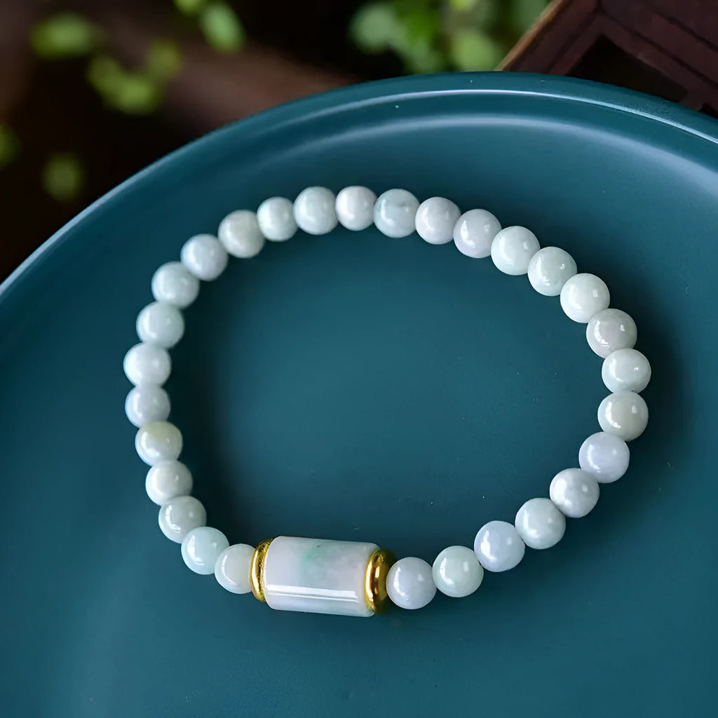 A close-up of a round Myanmar ice jade bead bracelet in emerald colour.