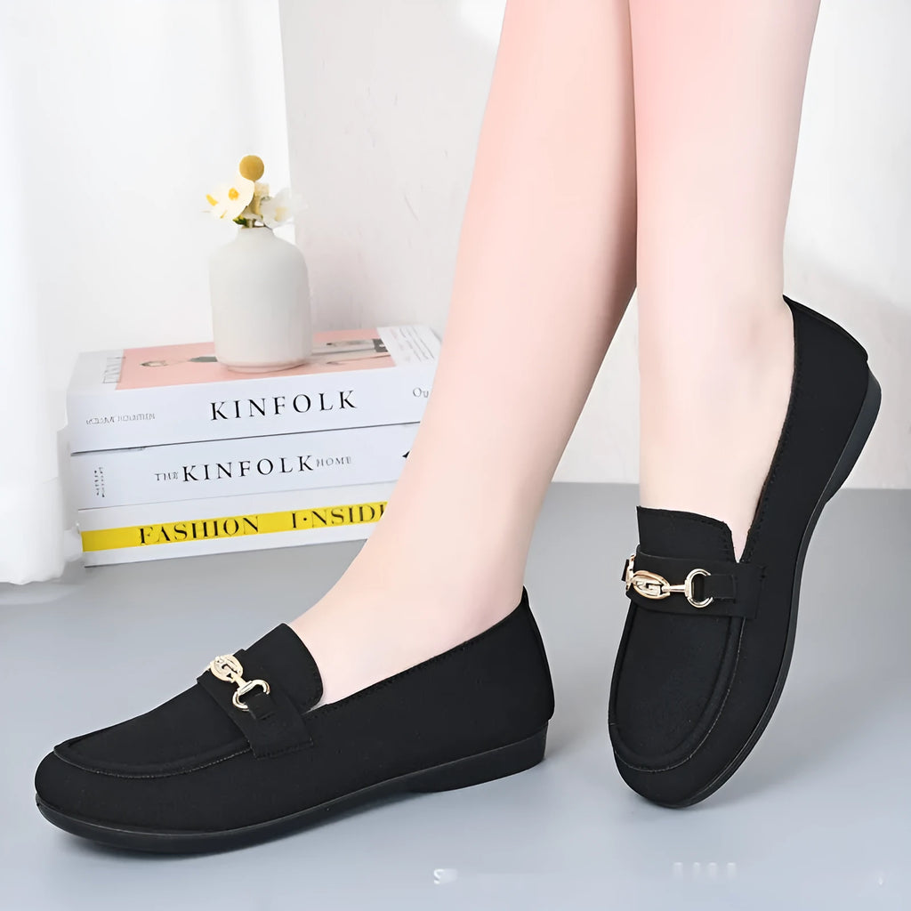 Gommino women's black slip-on casual shoes with a round toe and soft rubber sole on a neutral background.