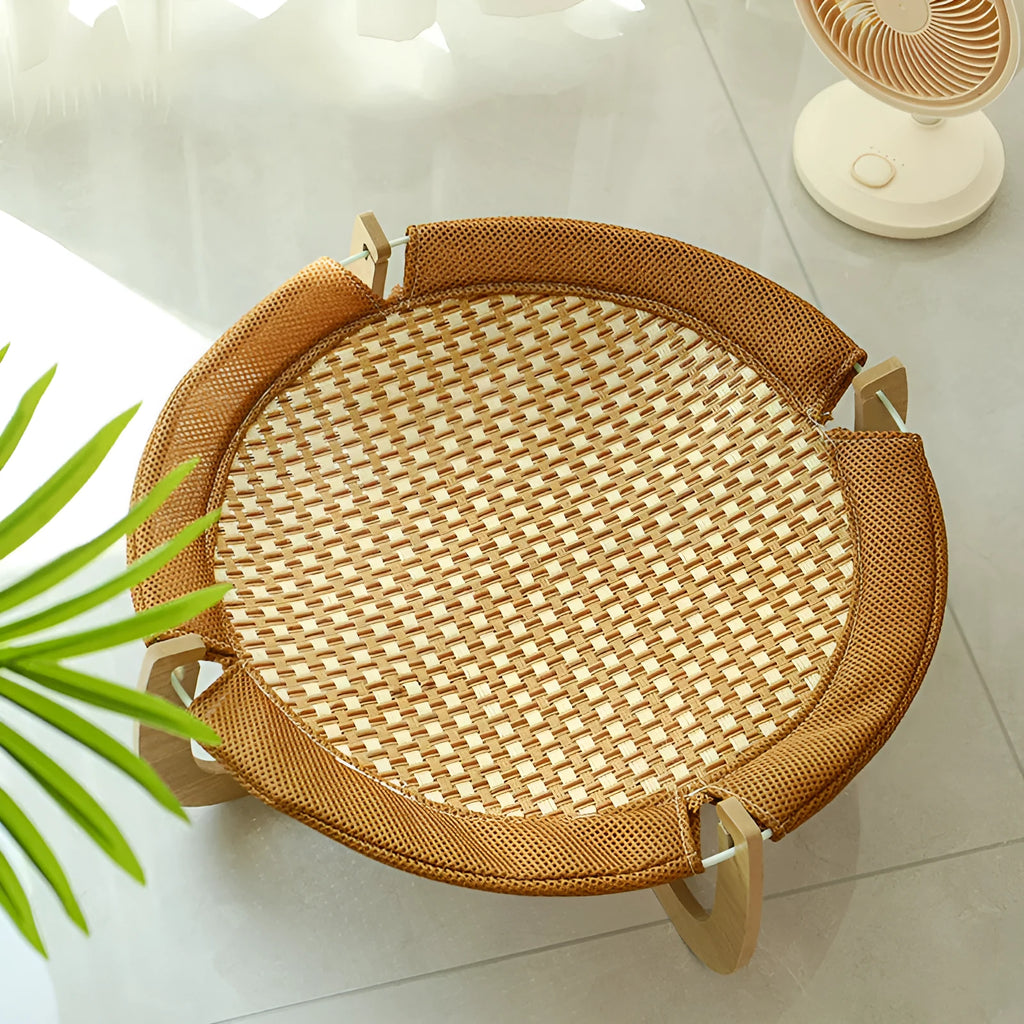 Brown woven rattan square pet hammock bed elevated off the ground.
