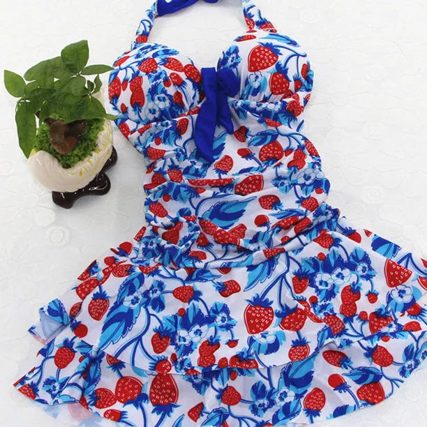 Blue strawberry print one-piece swimsuit with cross-strap backless design and push-up padding.