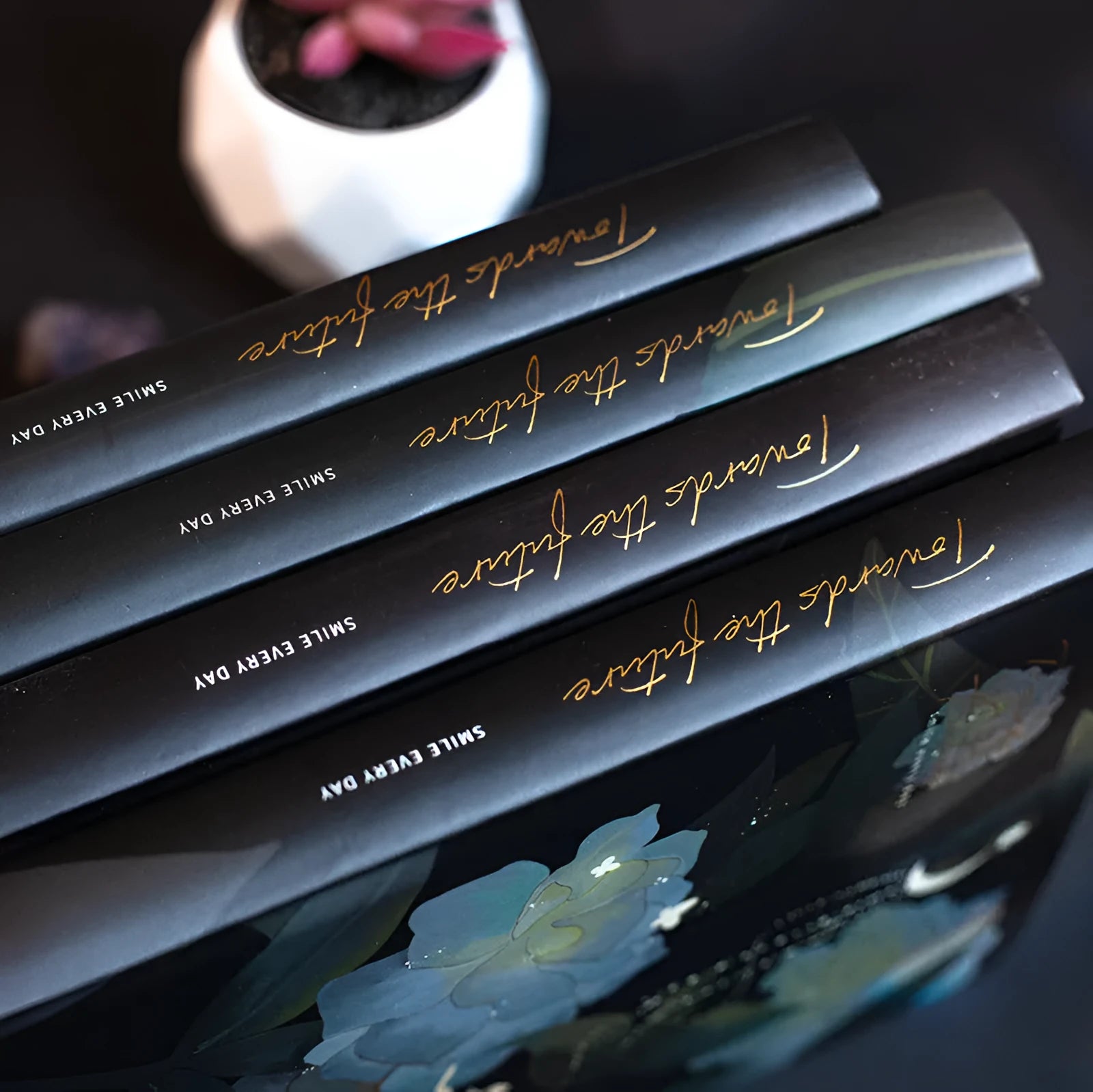 A5 notebook with luminous cover open to show pages filled with colour illustrations.