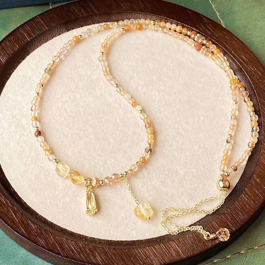 Caramel coloured citrine crystal women's bracelet with multi-layer design and Saturn decorative elements