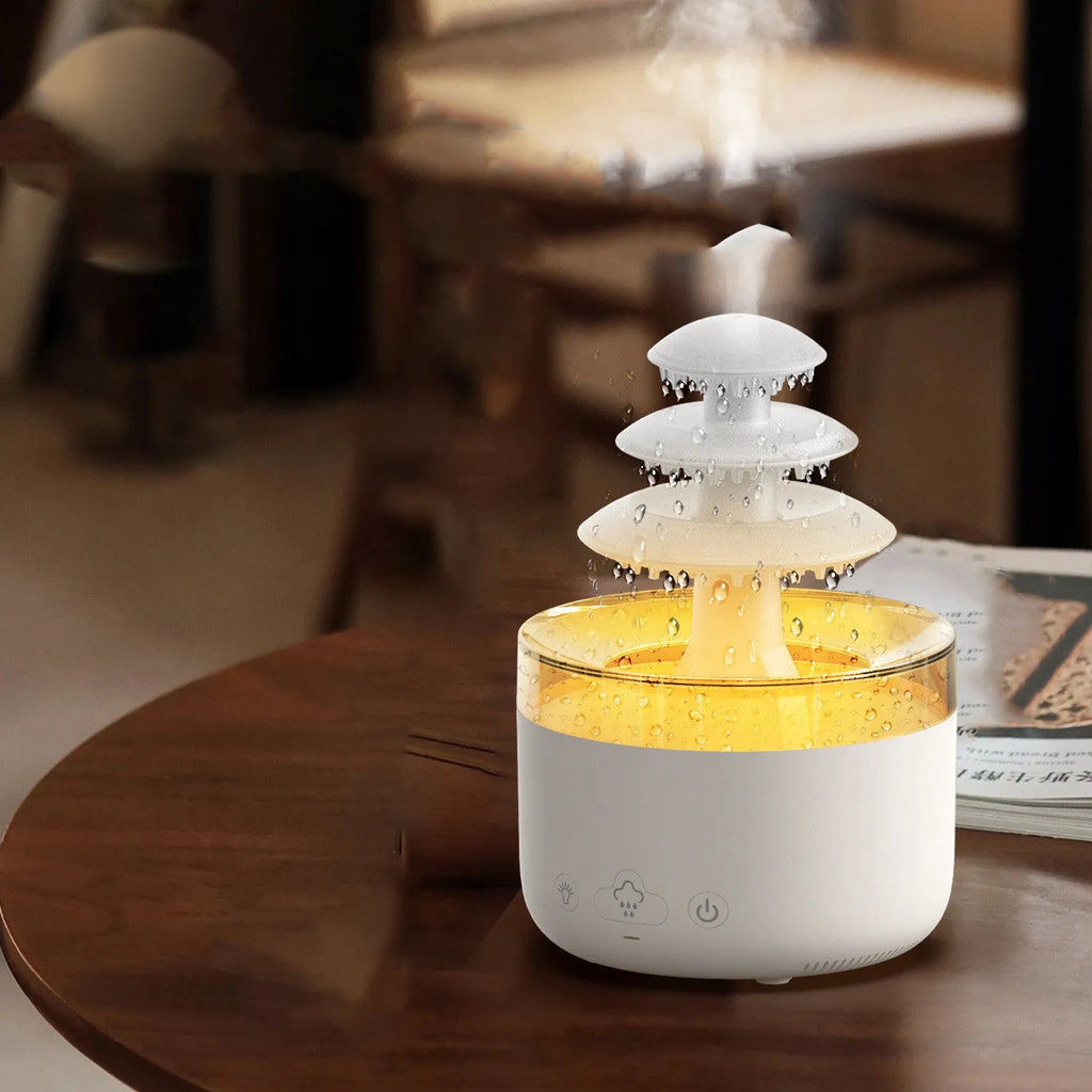 White Cloud Rain air humidifier and essential oil diffuser with colourful LED light on a table.