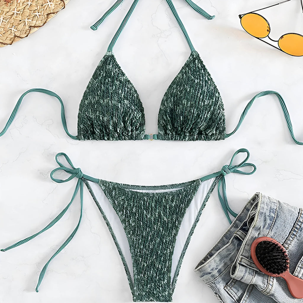 Green women's backless swimsuit with three-point halter strap design showing front and back views