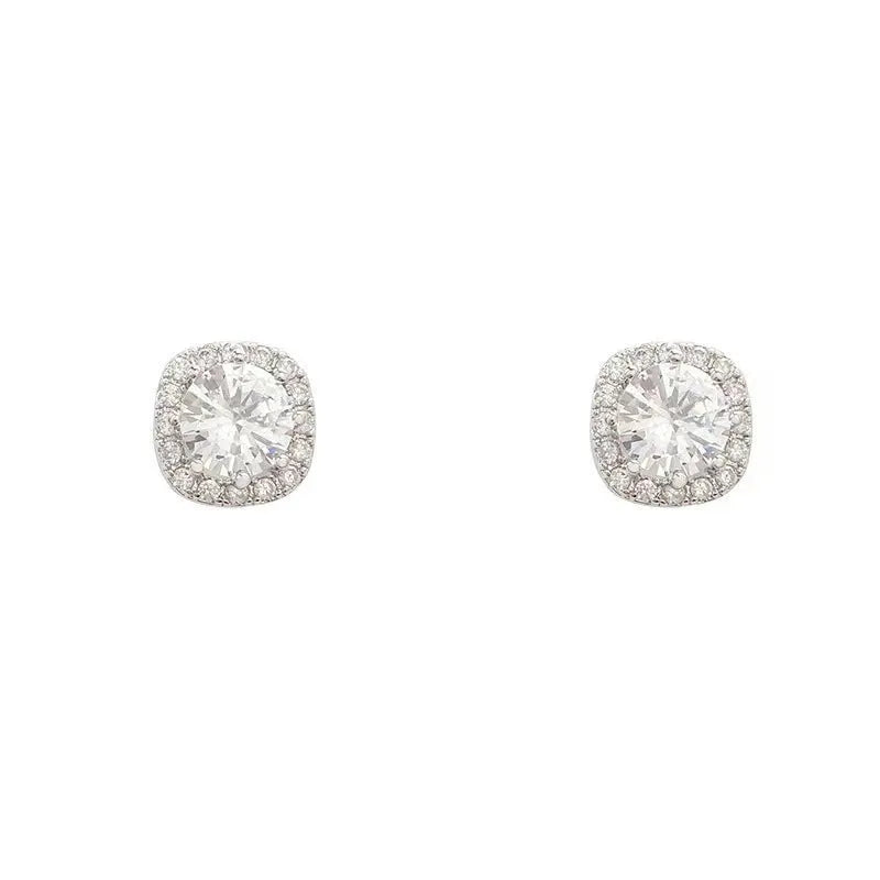 A pair of geometric quadrilateral diamond stud earrings in gold and silver colours.
