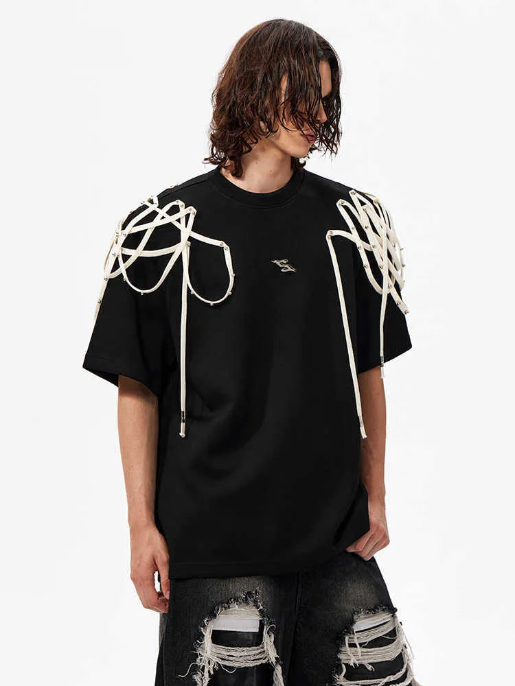 Black loose fit women's T-shirt with padded shoulders and decorative rivet ribbon detail.