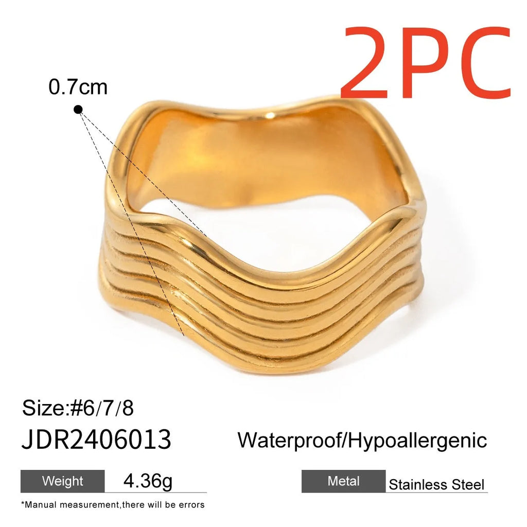 Stainless steel geometric wave ring with a wide band and electroplated finish.