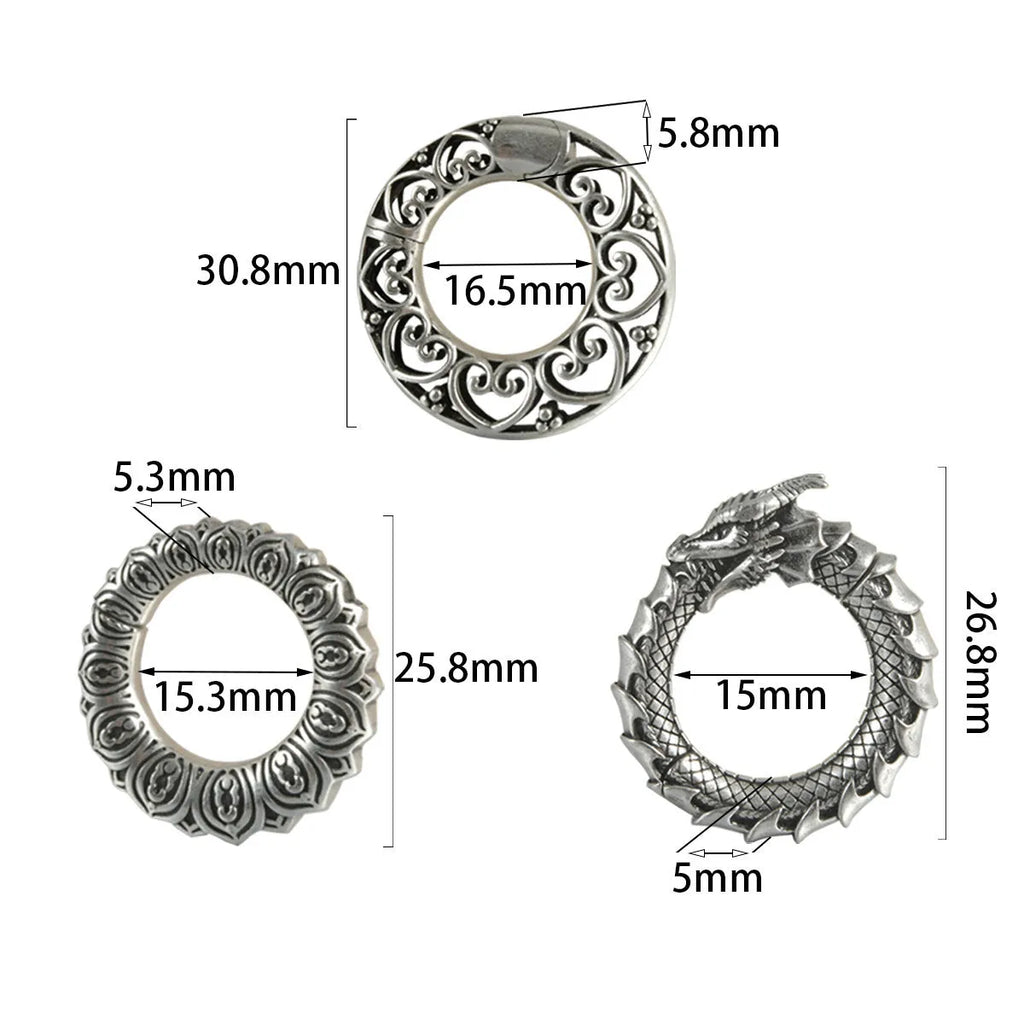 Pair of antique silver dragon-shaped hollow-out earrings with geometric design on a white background