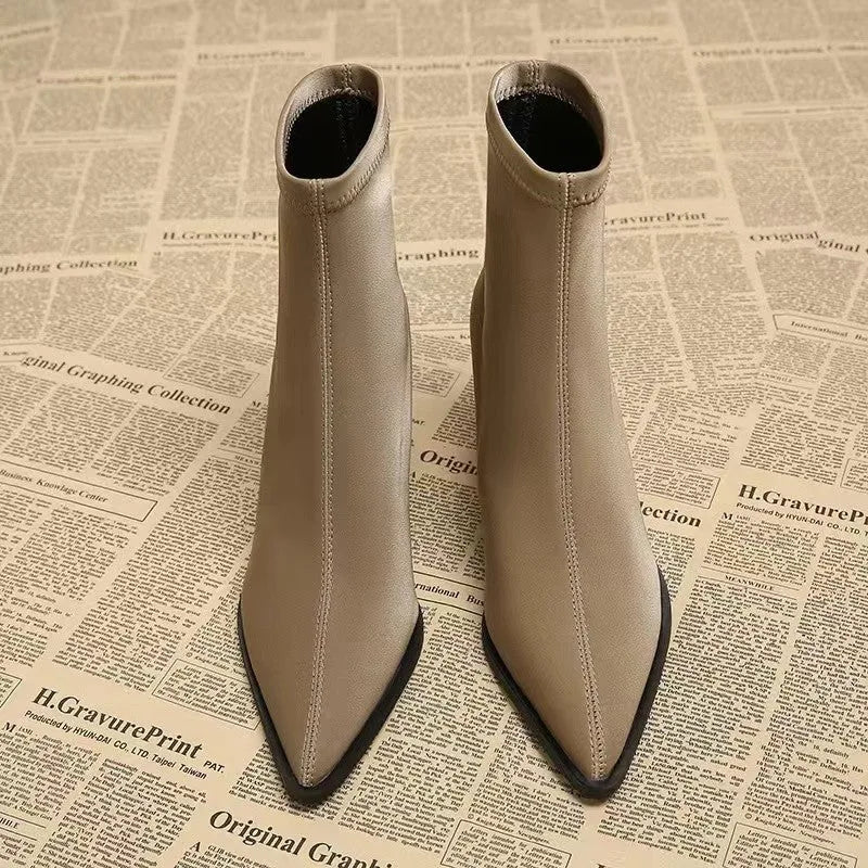 Women's khaki pointed toe ankle boots with a wedge heel on a white background.