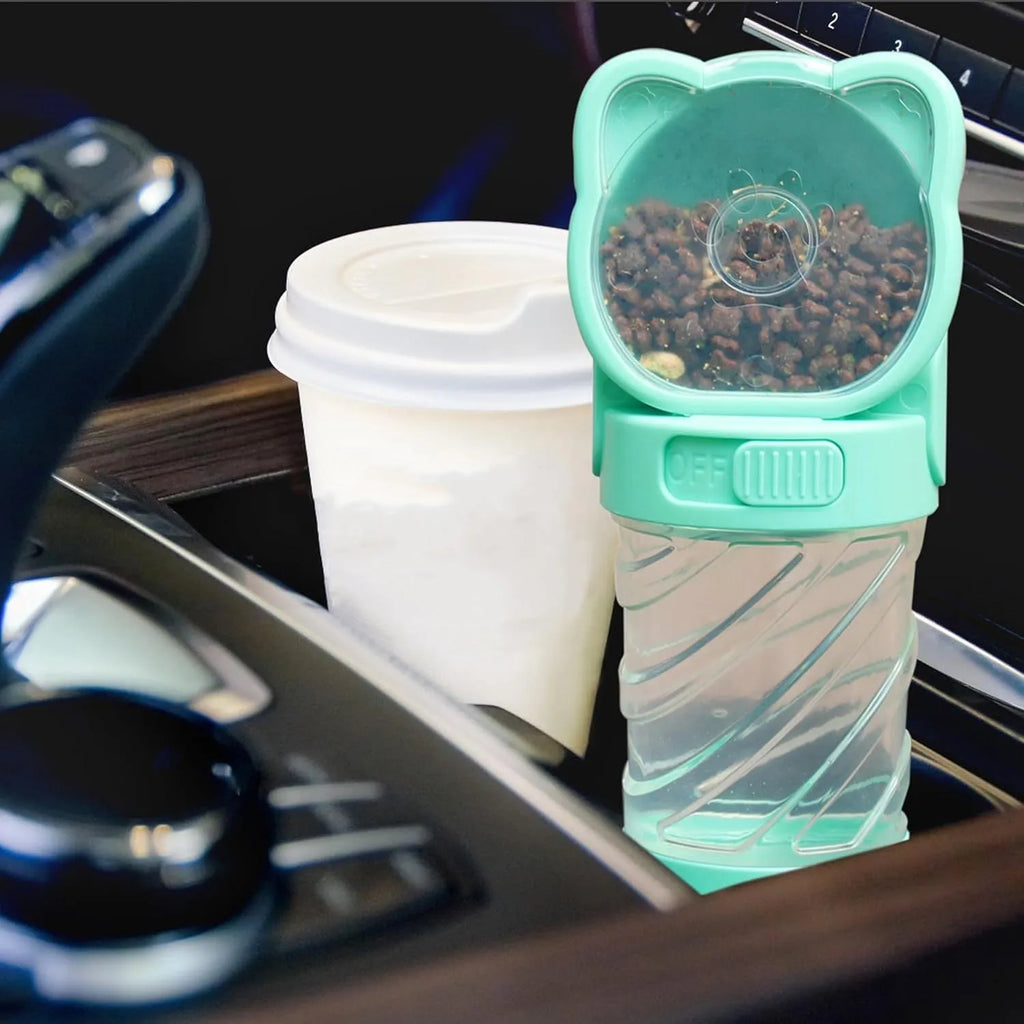 Green 3-in-1 portable pet water bottle with bowl, food container, and bag dispenser attached to a strap.
