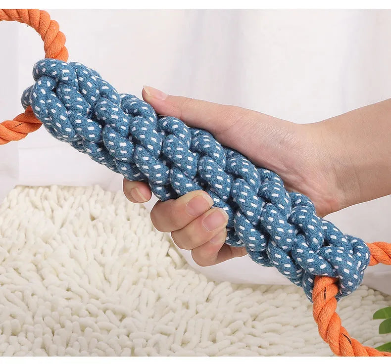Blue braided cotton rope dog toy shaped like a bone with two rings, on a white background.