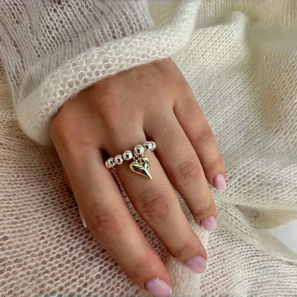 Handmade elastic beaded love ring with geometric heart design in gold and white electroplated finishes