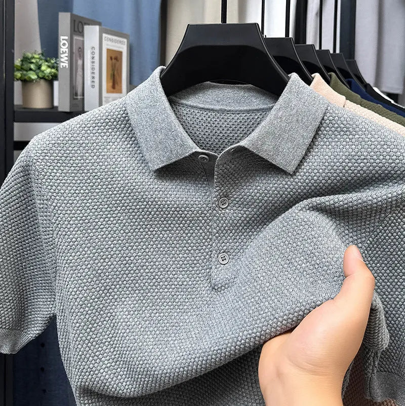 Man wearing a loose grey cotton short sleeve pullover sweater for casual leisure wear.