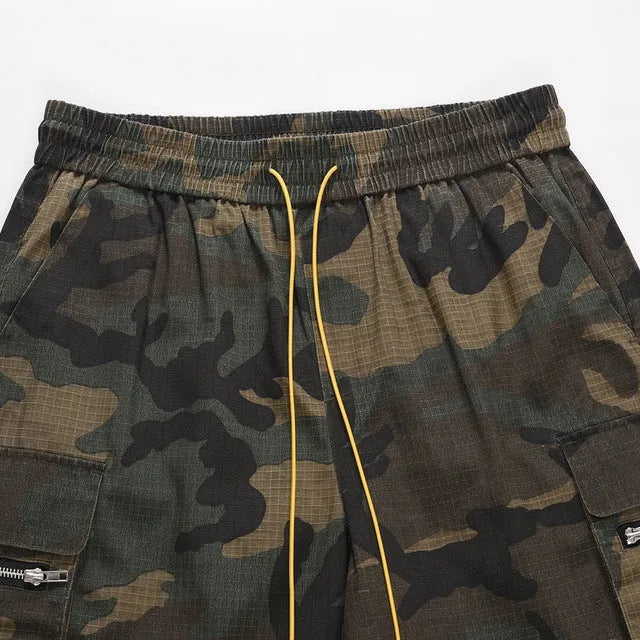 Green washed camouflage cotton cargo shorts with multiple pockets on a mannequin