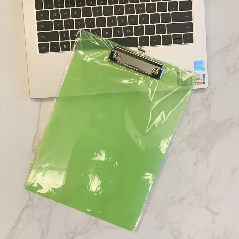 Transparent A4 writing board pad with metal clip holding paper, shown in blue colour option