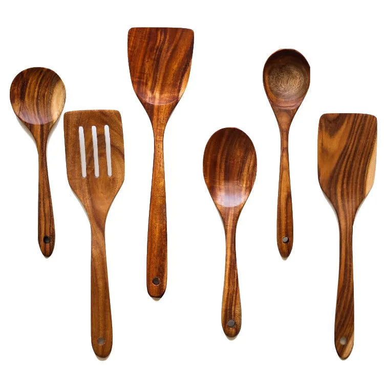 Seven wooden cooking utensils including spoons and spatulas arranged together