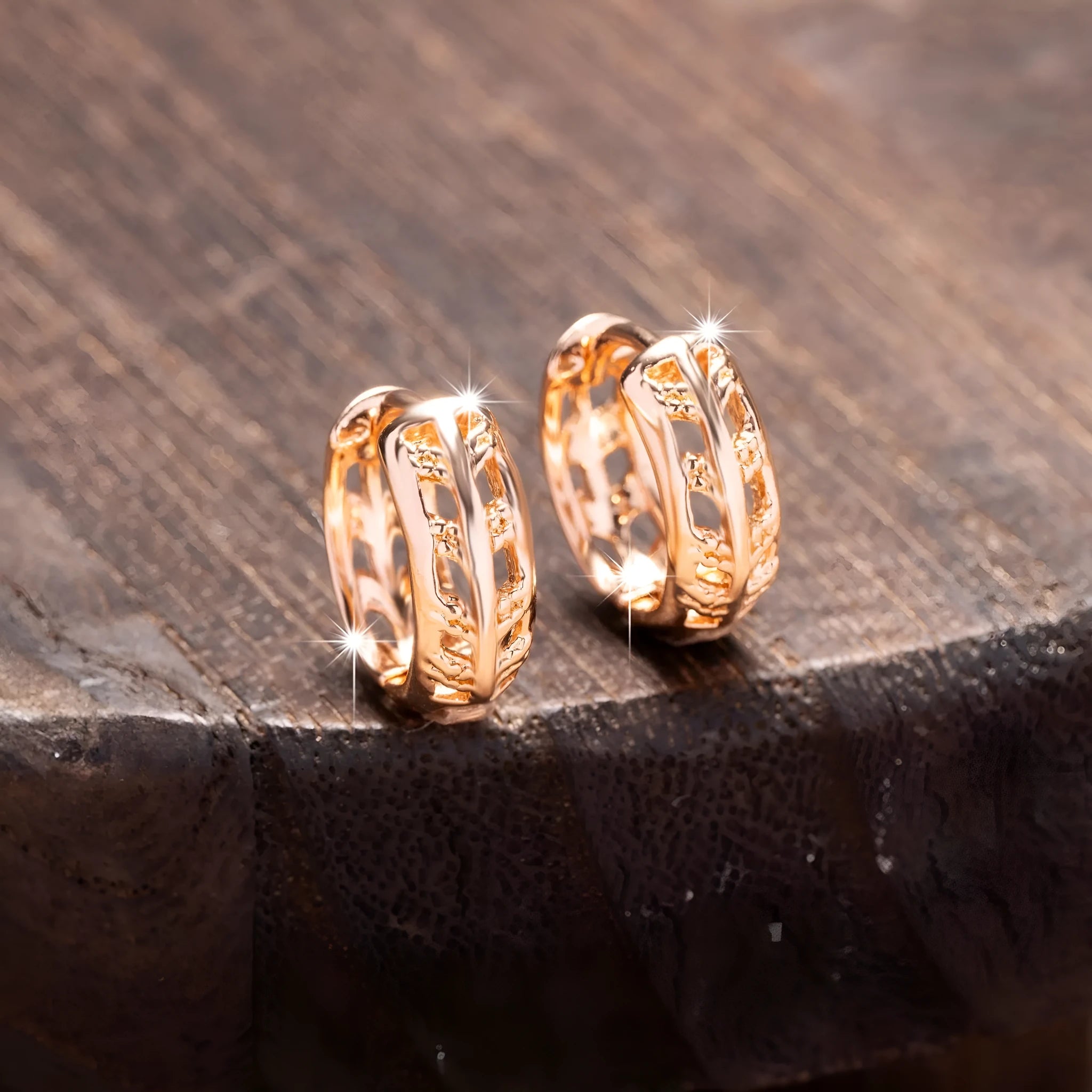 Close-up of rose gold hollowed-out heart and leaf drop earrings showing intricate open metalwork and 2.8cm length.
