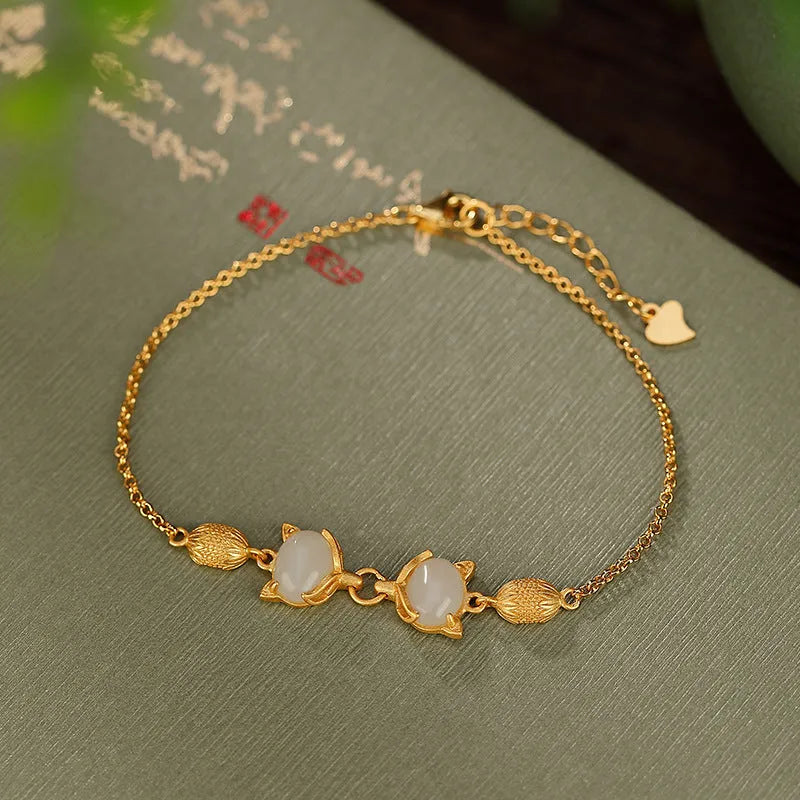Close-up of a women's silver bracelet with a detailed retro fox charm on an adjustable chain.