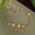 Close-up of a women's silver bracelet with a detailed retro fox charm on an adjustable chain.
