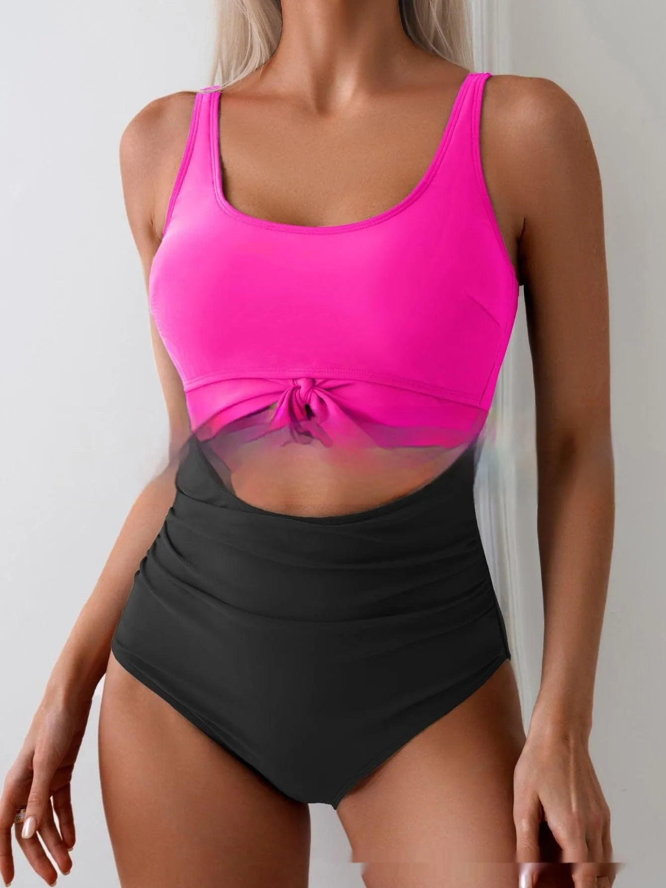 One-piece female swimsuit with contrast colour straps and covered belly in rose-red and black