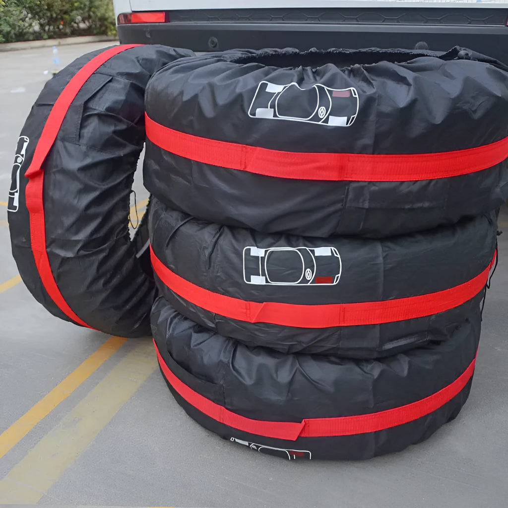 Set of four black Oxford cloth car tyre protective covers laid flat