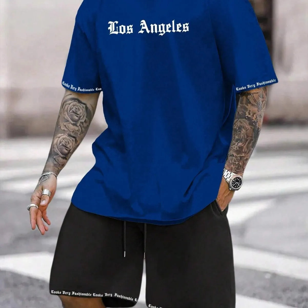 Men's blue sports style short-sleeved top and matching shorts laid flat