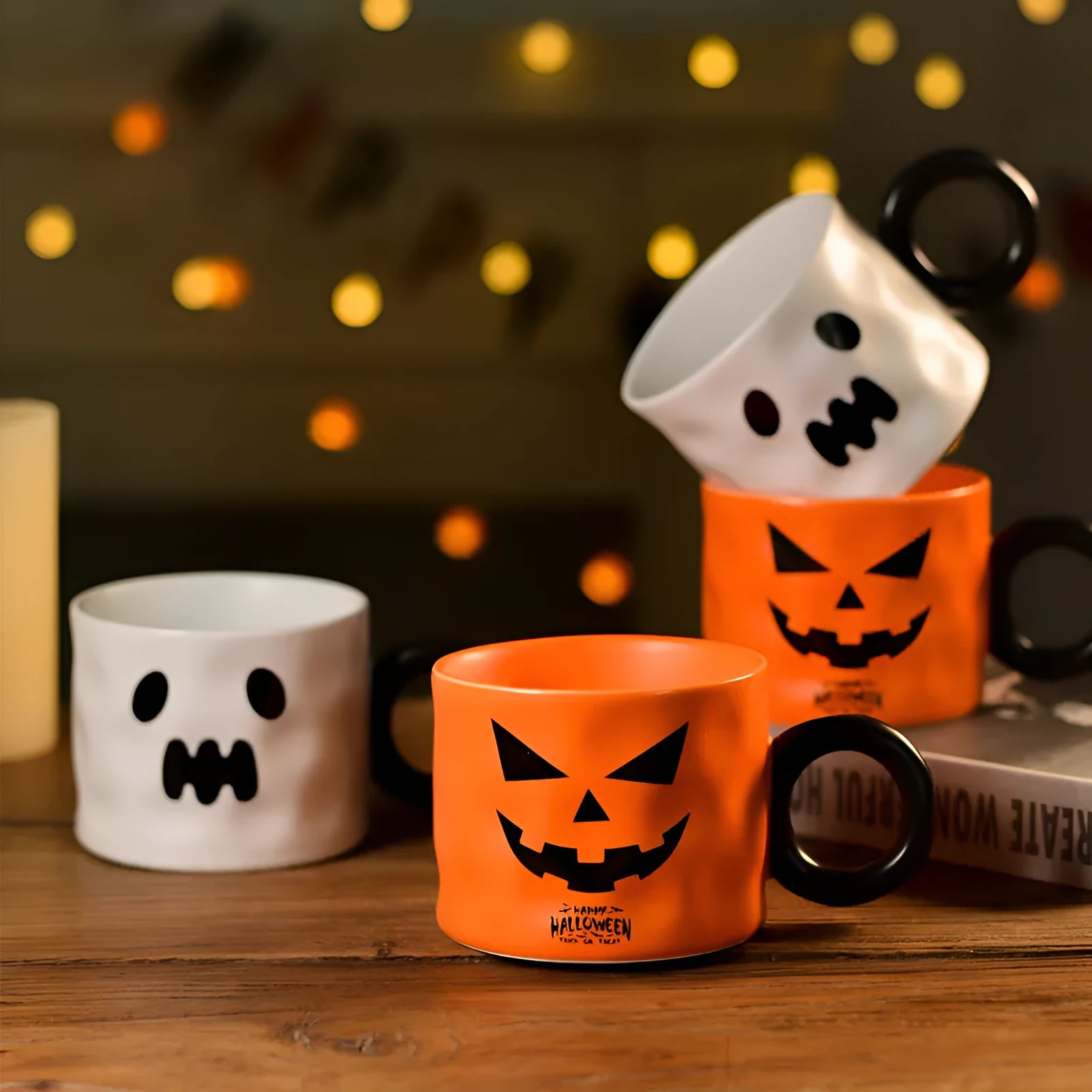 Orange ceramic Halloween pumpkin cup with handle beside dessert spoon in gift box