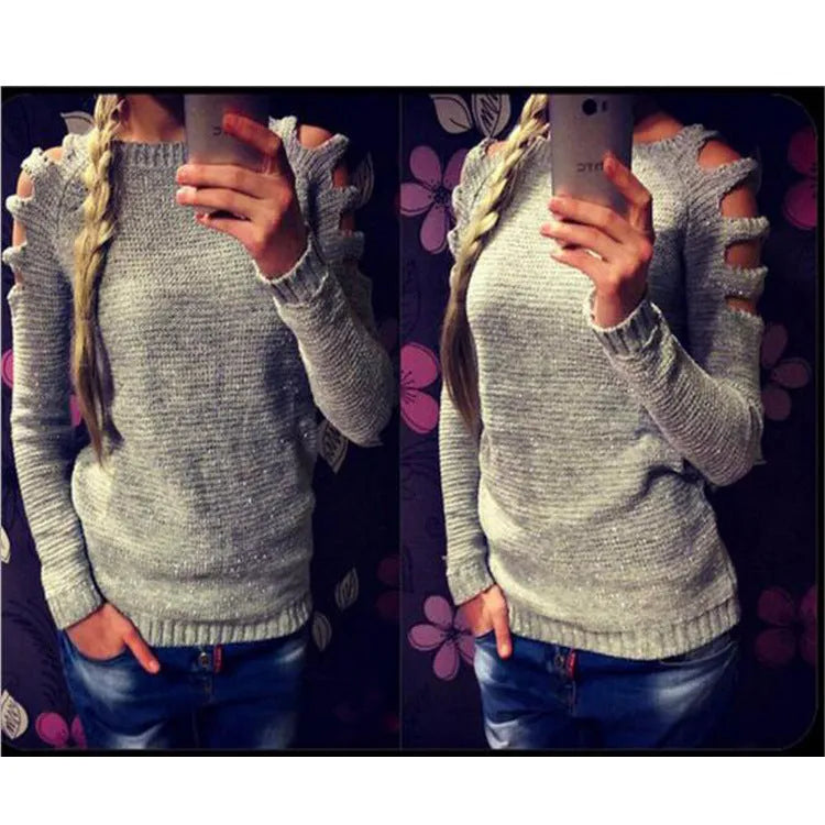 Women's grey hollow-out crochet long sleeve knit shirt on a hanger.