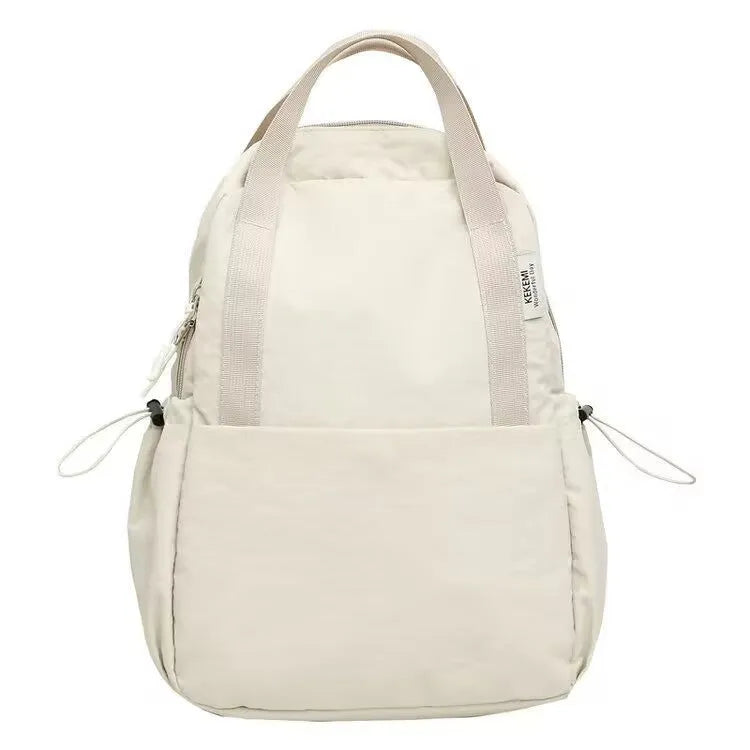 Solid colour nylon backpack with curved shoulder straps shown in five colour options