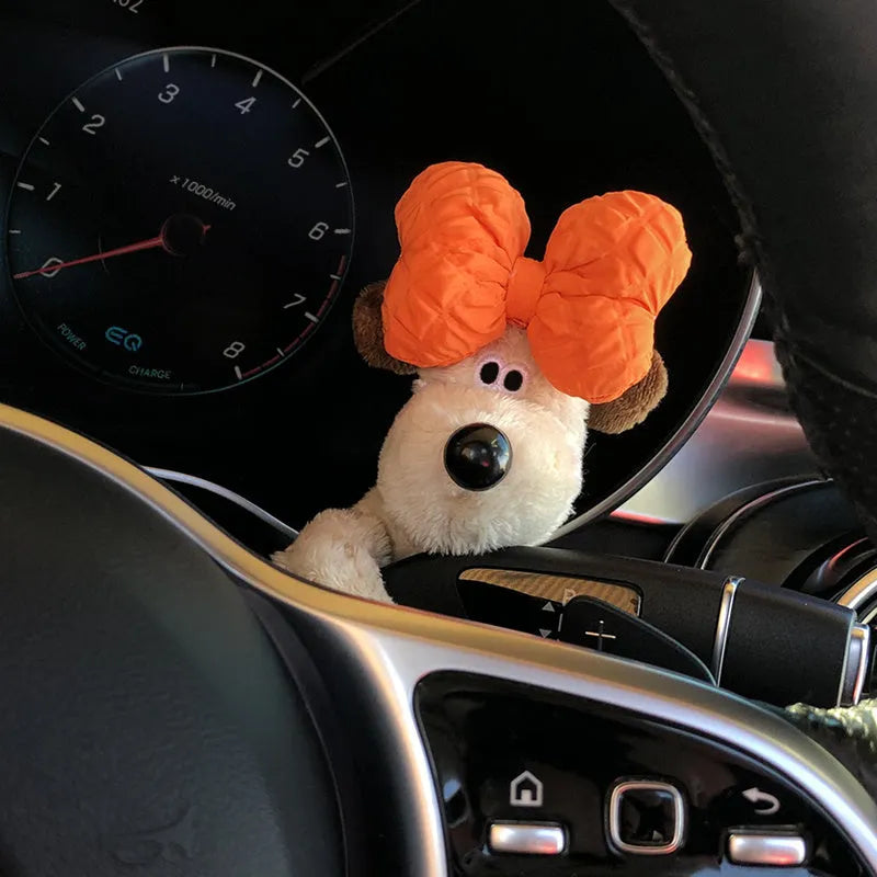 Cute cotton car decoration doll showing a pilot dog design on a dashboard.