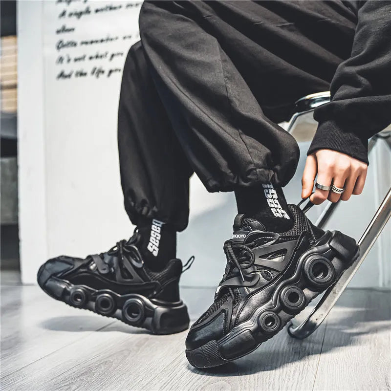 Men's low-top casual sneakers in black with a mesh upper, thick rubber sole, and round toe.