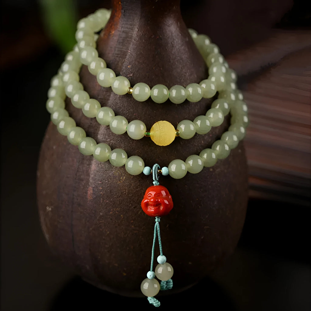 Pale blue Hetian jade bracelet with three circle design and 6mm beads on a wrist.
