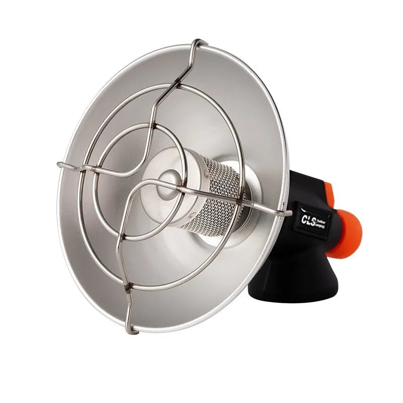 Black and orange portable camping heater stove with automatic ignition on a rocky outdoor surface.