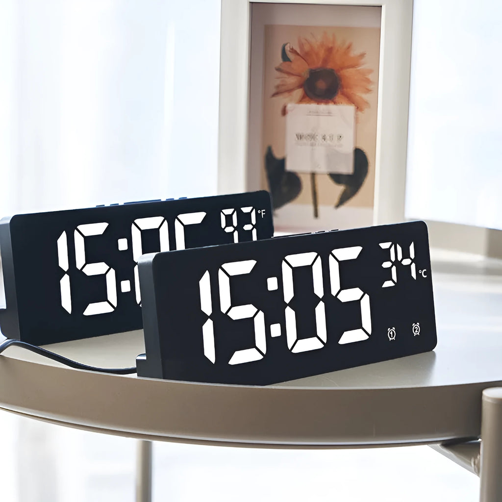 Large screen electronic LED alarm clock showing time and temperature, in a black acrylic casing.