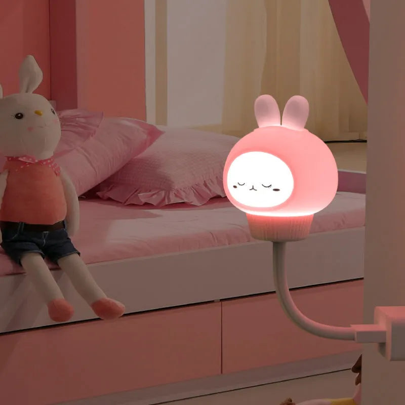 White USB cartoon animal night light in bear design with remote control on wooden table.